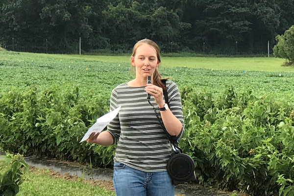 Maggie Lewis speaking about her research on spray coverage in caneberries to an audience of growers, extension agents, and university researchers at the Western Maryland Research and Education Center Horticultural Twilight Meeting and Tour
