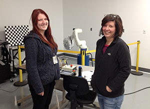 Laura Nixon and Tracy Leskey standing in front of a robot