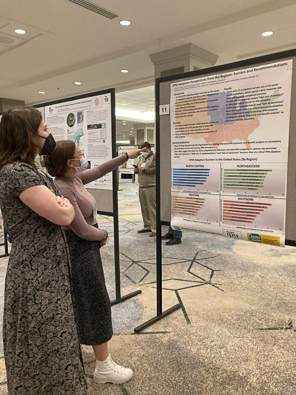 IPM Symposium attendees looking at poster display