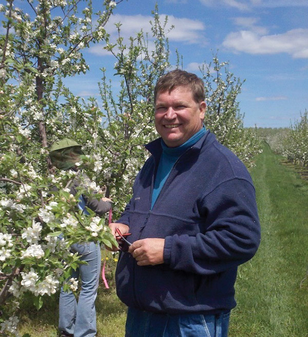 Larry Gut in an orchard