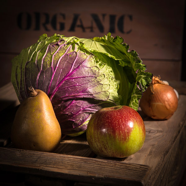 Still life with cabbage, pear, apple, and onion