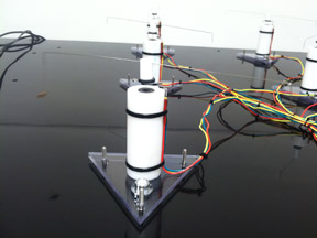 A flight mill, shaped like a rotating wire atop a tower, spins to measure the speed and distance of an insect.