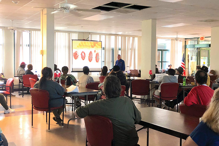 Residents attend a bed bug education program.